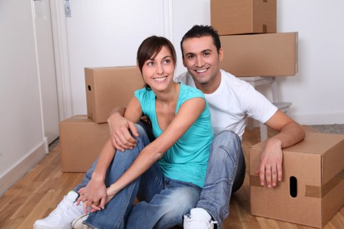 Professional man and van moving boxes and furniture in Sutton