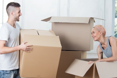 Packed moving boxes and furniture ready for transport in Sutton